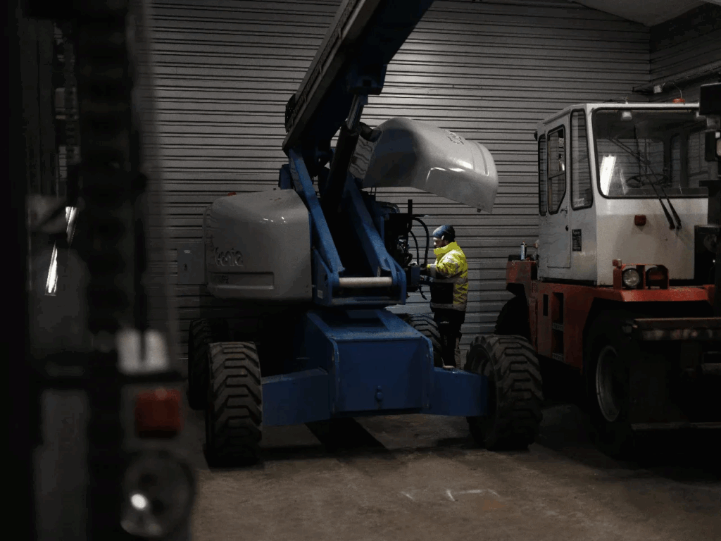 Worker operating crane inside warehouse – Tangen heavy industry.